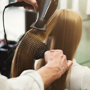 Person getting hair dried in a salon